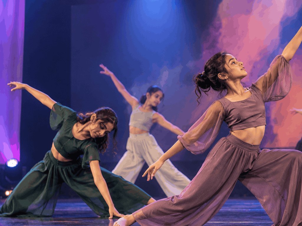 Contemporary dancers in a flowing group piece on stage