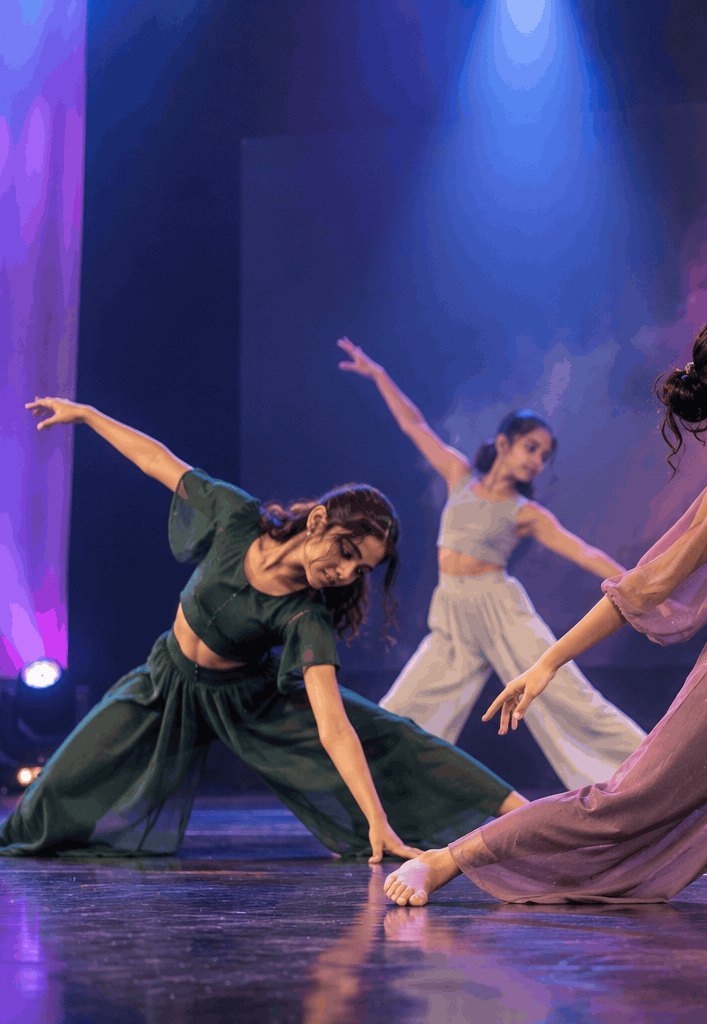 Contemporary dancers in a flowing group piece on stage