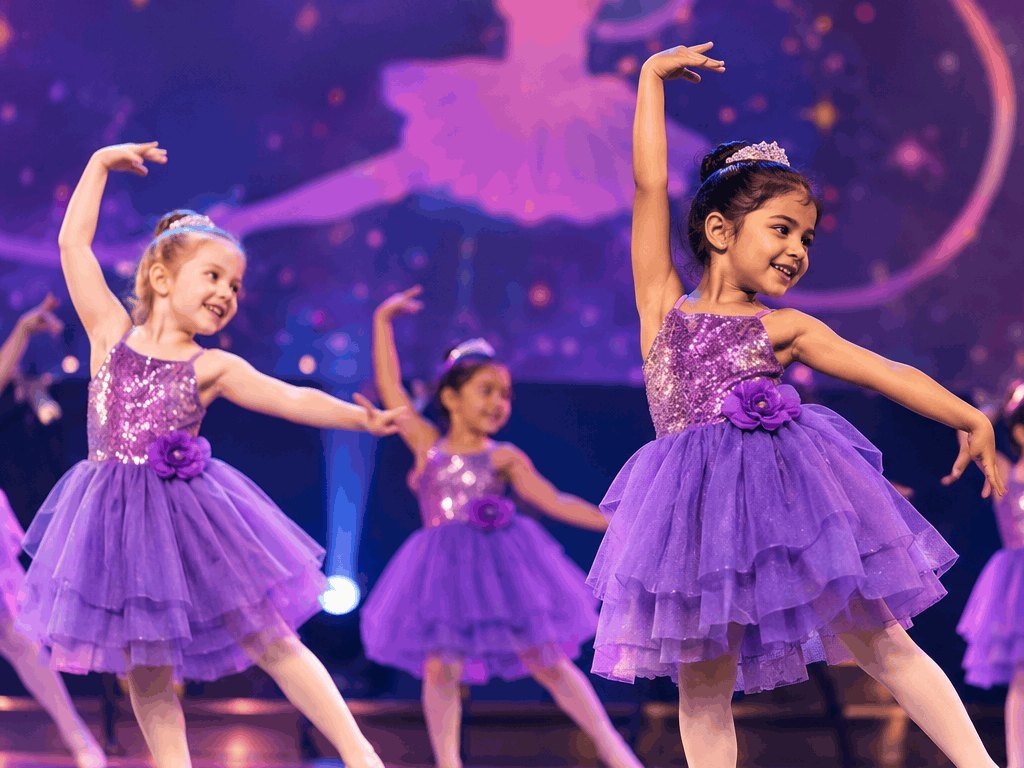 Little ballet dancers in lilac tutus on stage